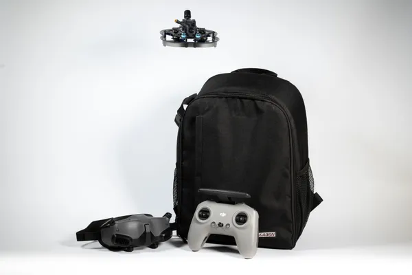 Full kit — drone, goggles, controller and backpack.
