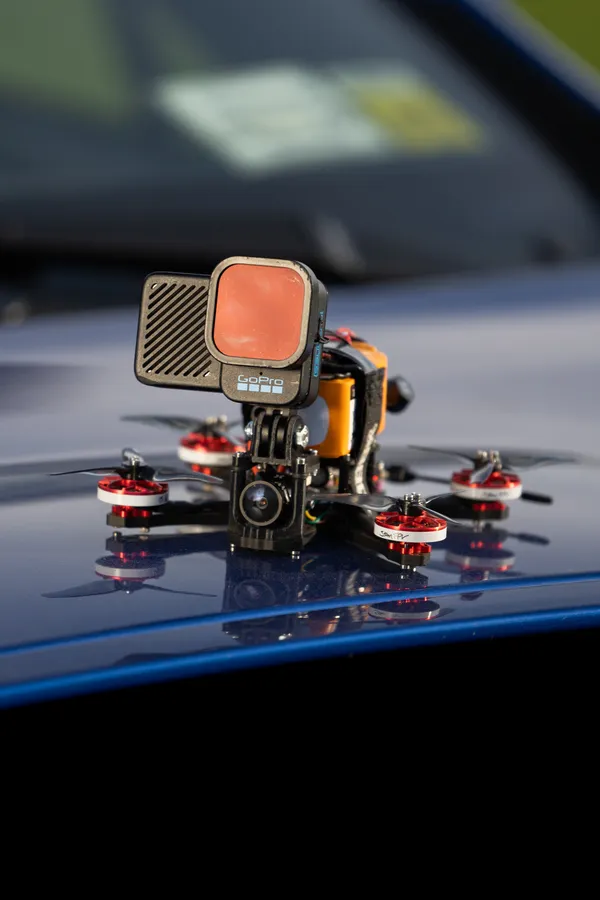 Pursuit drone with action camera, ready to chase.