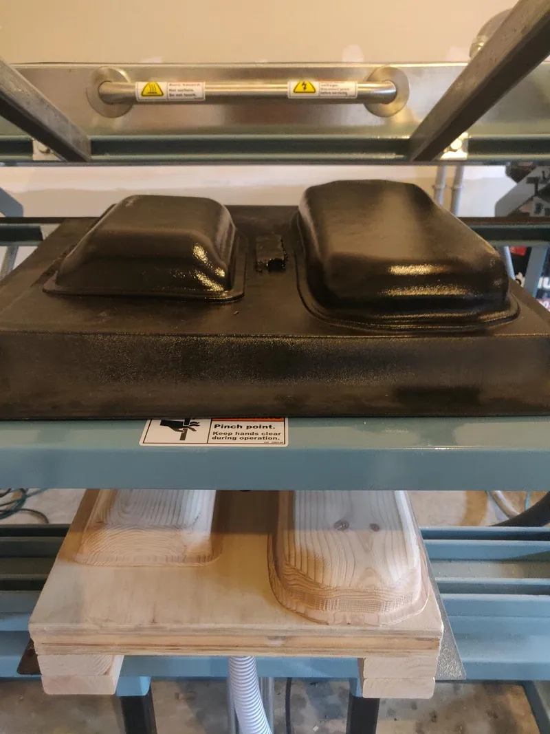 Formed shells on the vacuum former, with the bucks below.